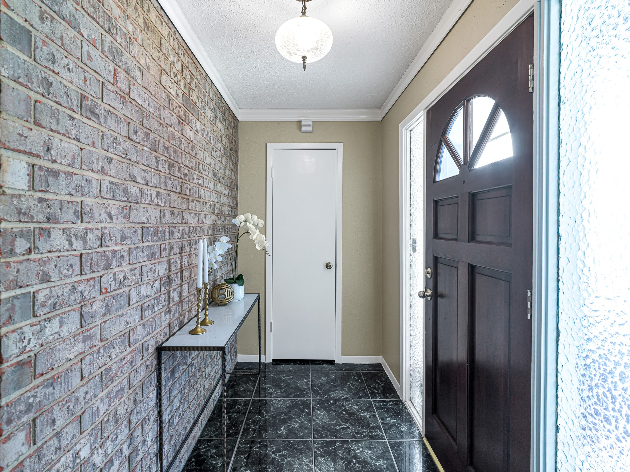 6230 Sunnygate Drive Spring, TX 77373 - Photo 6 of 33 Entryway features a brick accent wall and efficient coat closet.