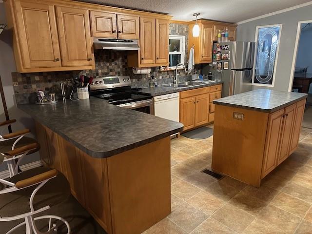 2100 Dove Loop Road, Unit 30 Grapevine, TX 76051 - Photo 25 of 29 a kitchen with kitchen island granite countertop a stove top oven a sink a counter space and cabinets