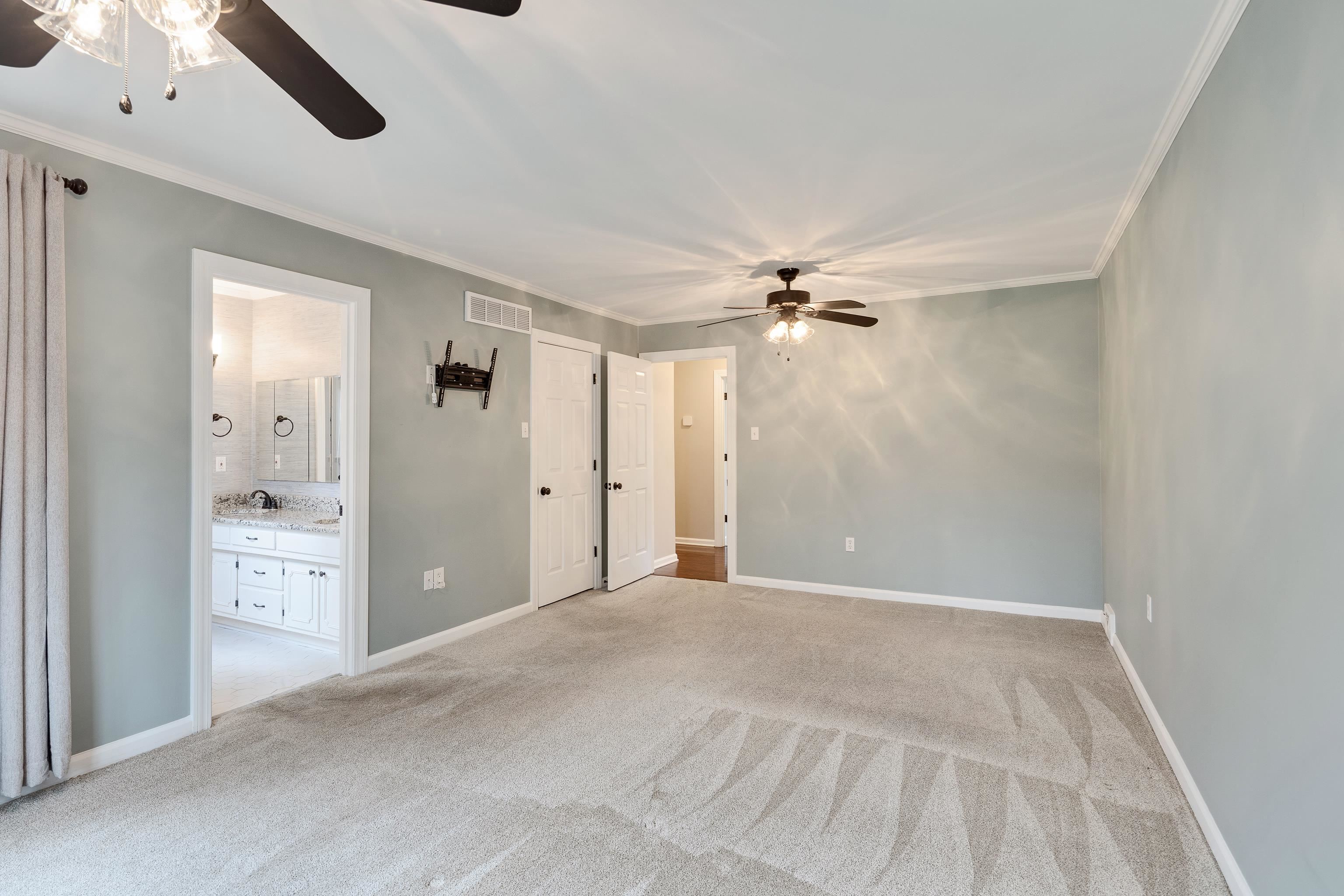 1658 Miller Farms Road Germantown, TN 38138 - Photo 17 of 39 Unfurnished bedroom featuring crown molding, a ceiling fan, light colored carpet, and ensuite bathroom