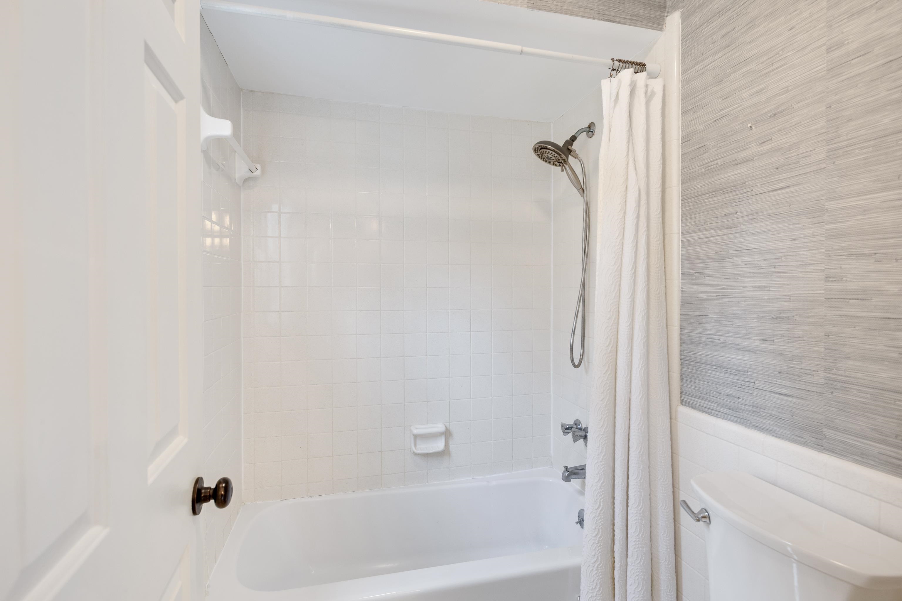 1658 Miller Farms Road Germantown, TN 38138 - Photo 19 of 39 Bathroom featuring shower / tub combo with curtain and a wainscoted wall