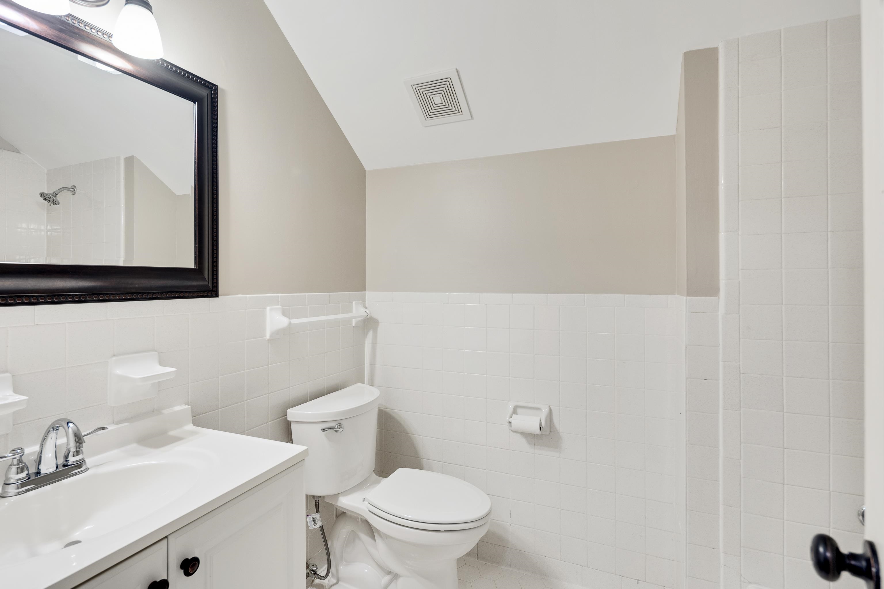 1658 Miller Farms Road Germantown, TN 38138 - Photo 30 of 39 Full bathroom with vanity, tile walls, wainscoting, and a shower
