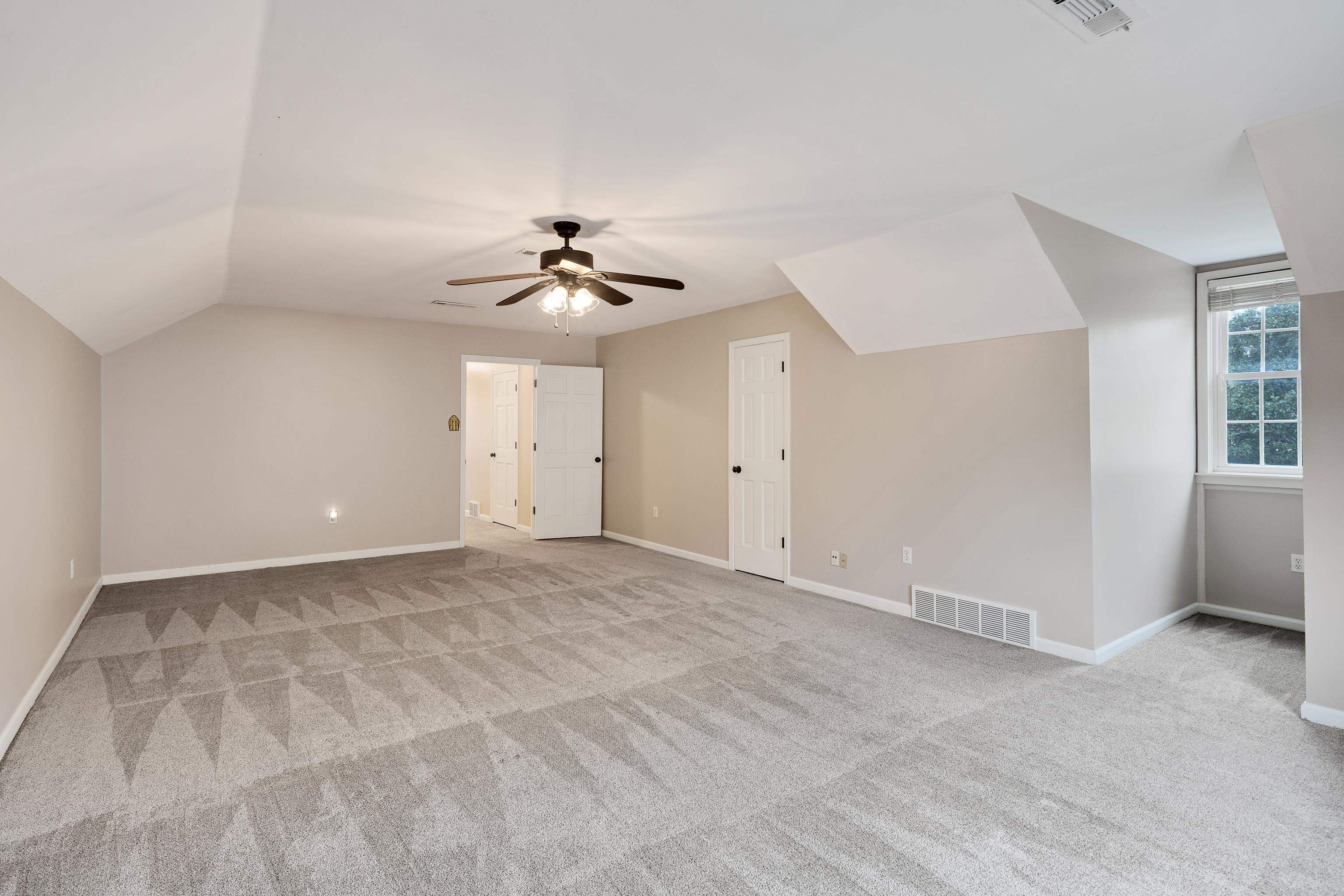 1658 Miller Farms Road Germantown, TN 38138 - Photo 32 of 39 Additional living space with lofted ceiling, light carpet, and ceiling fan