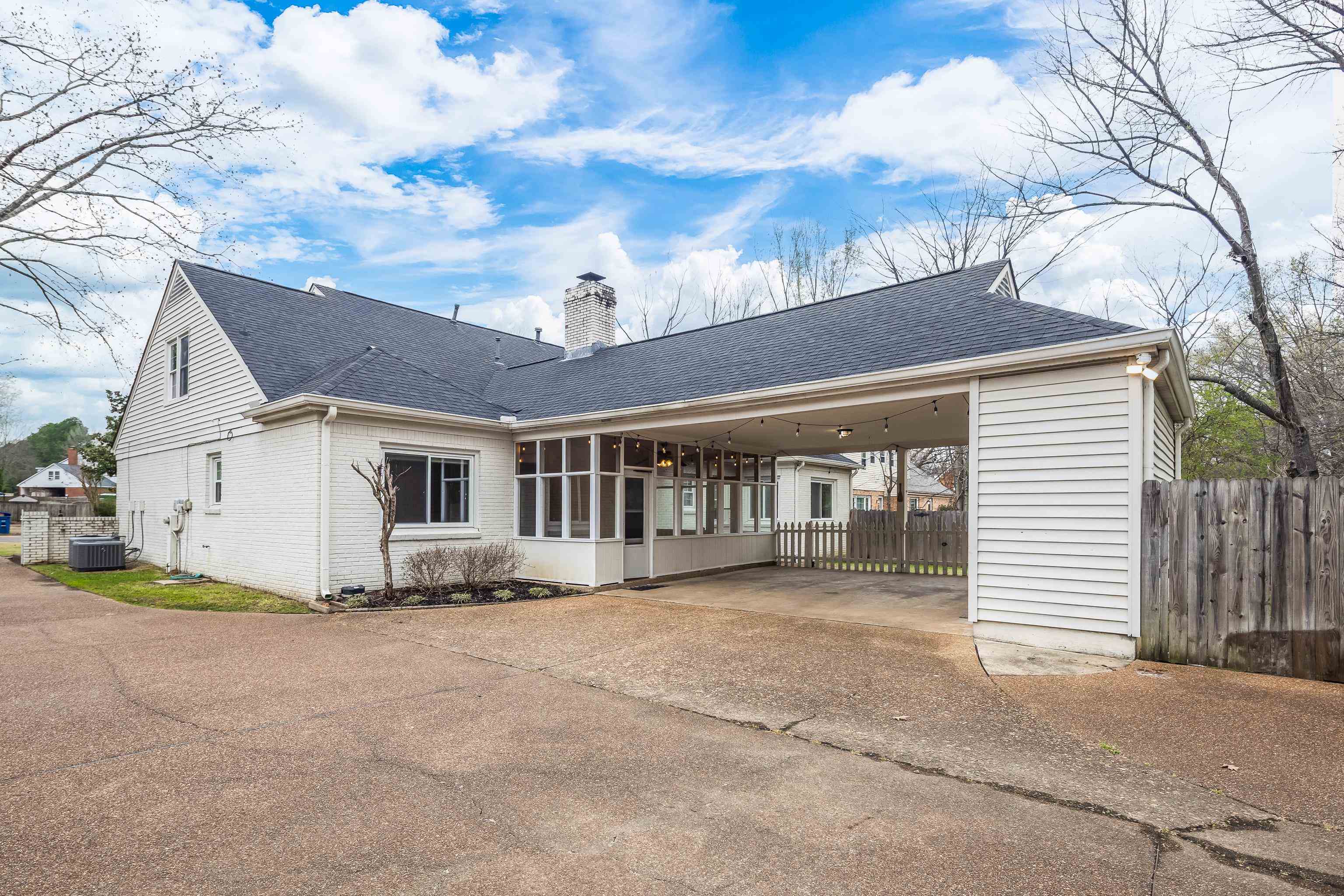 1658 Miller Farms Road Germantown, TN 38138 - Photo 34 of 39 View of front of home with roof with shingles, driveway, a chimney, a carport, and brick siding