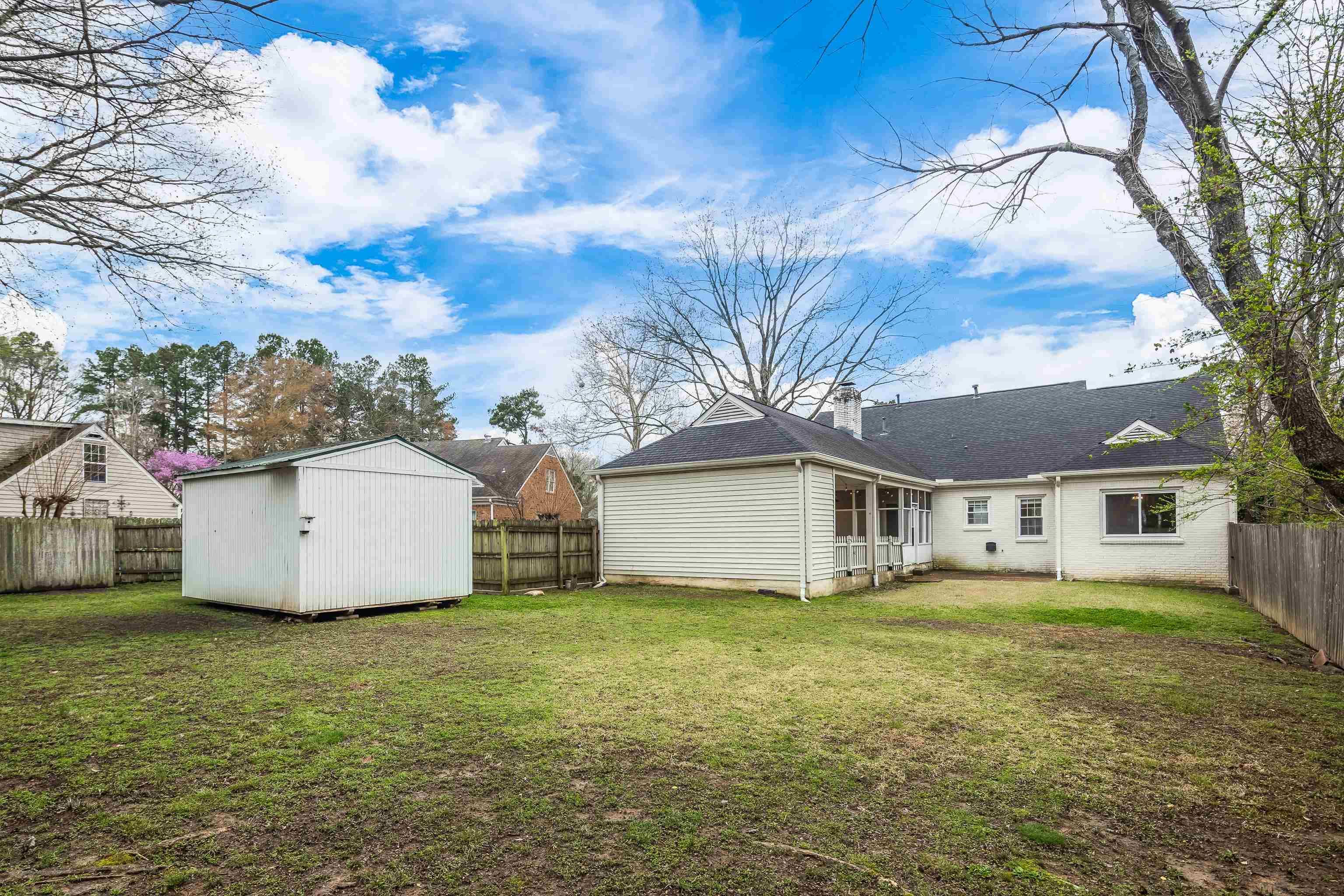1658 Miller Farms Road Germantown, TN 38138 - Photo 38 of 39 Back of house featuring a fenced backyard and a storage unit