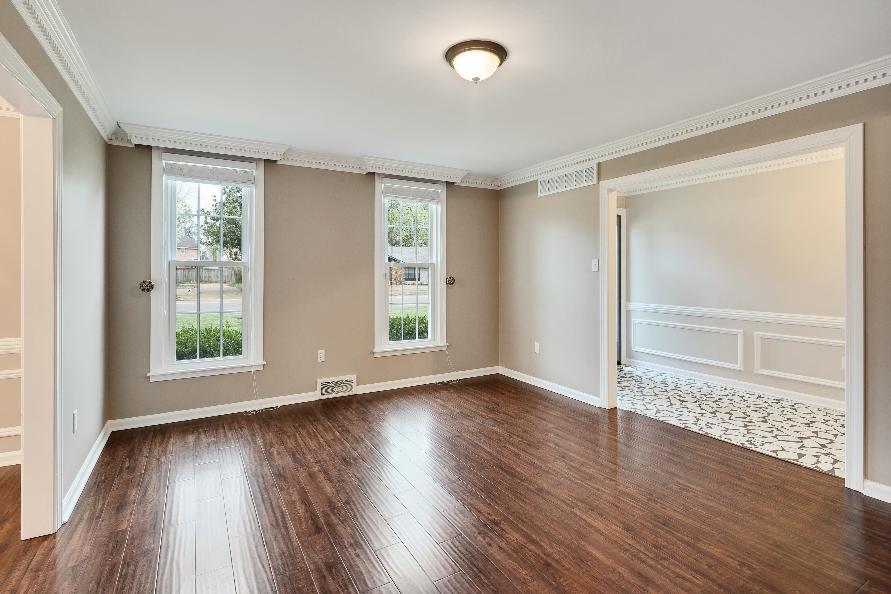 1658 Miller Farms Road Germantown, TN 38138 - Photo 5 of 39 Empty room with dark wood-style flooring and ornamental molding