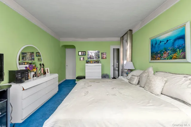 a spacious bedroom with a bed table and a couch