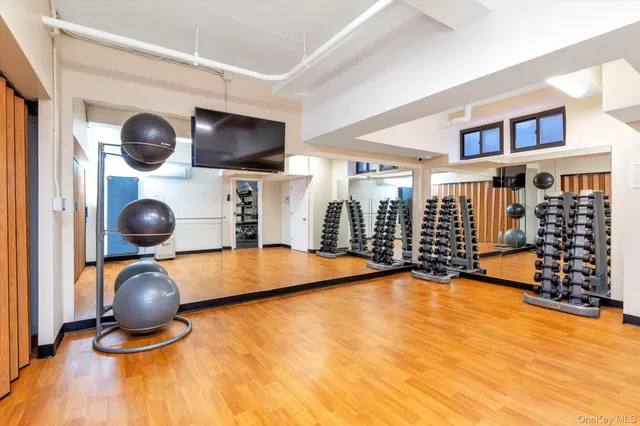 a room with gym equipment and a large window