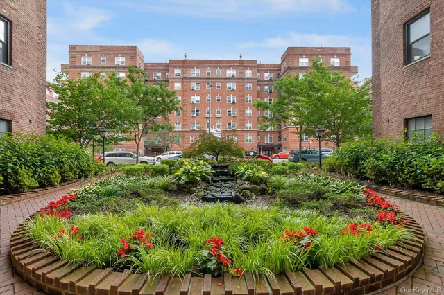 a view of a flower garden with a building in the background