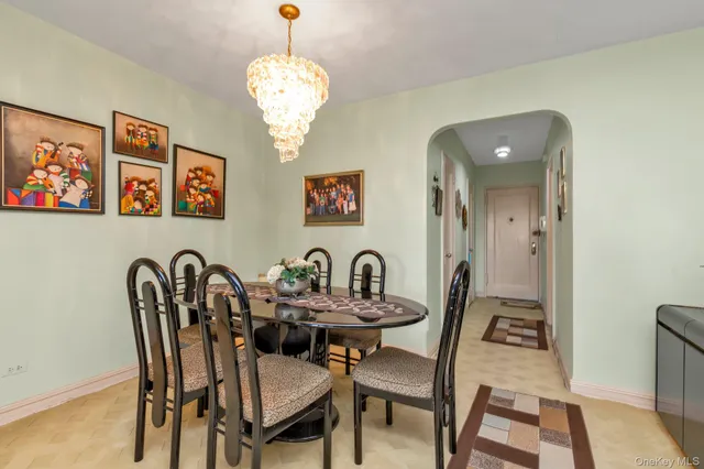 a dining room with furniture and chandelier