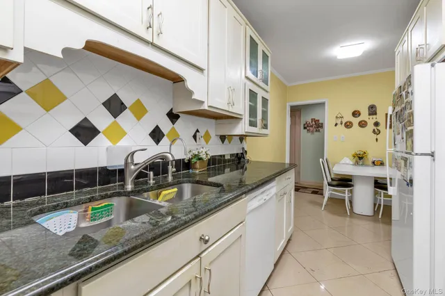 a kitchen with stainless steel appliances granite countertop a sink and a counter space