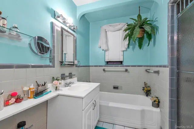 a bathroom with a sink a mirror and a bathtub