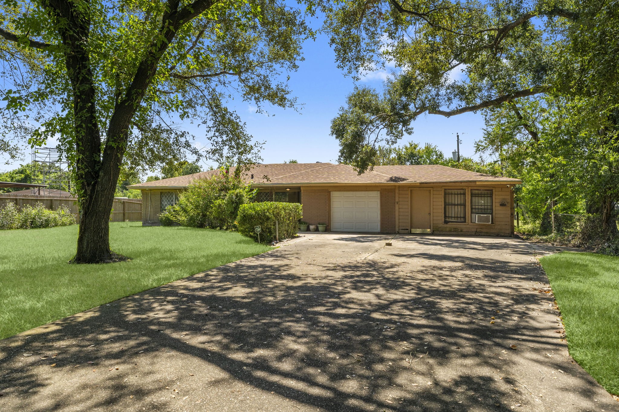 814 Isetta Lane Houston, TX 77060 - Photo 2 of 30 a front view of a house with a garden and trees
