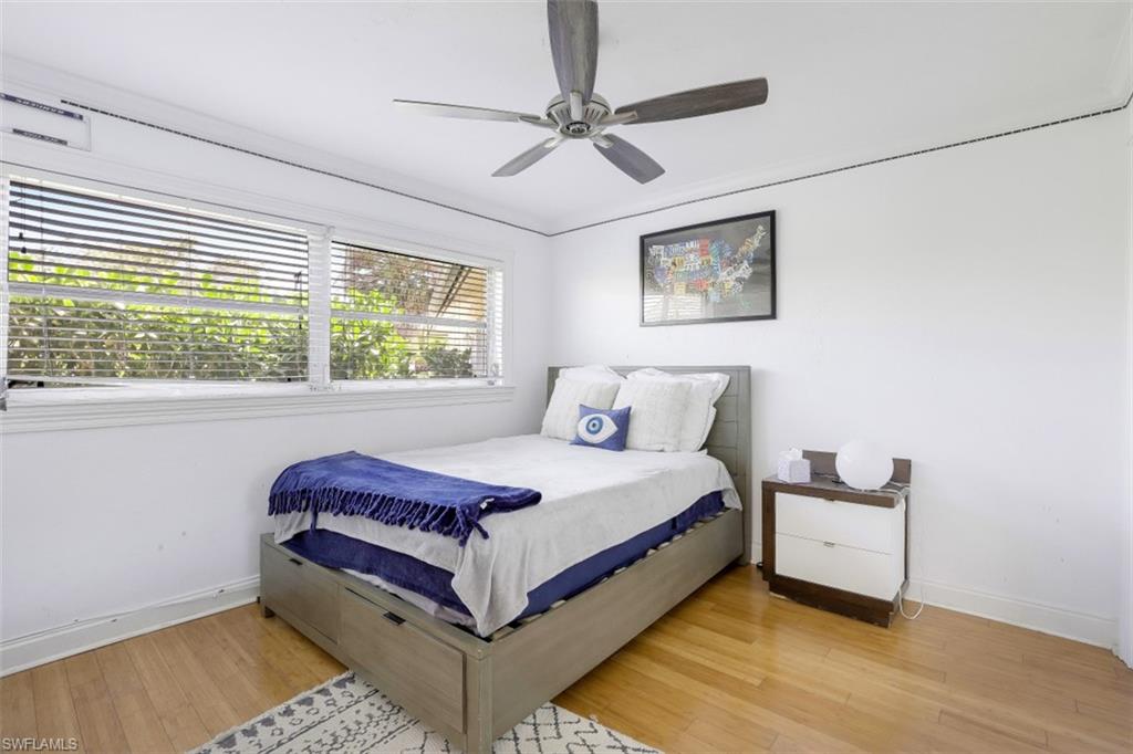 619 Neapolitan Way Naples, FL 34103 - Photo 18 of 32 a bedroom with a bed and a window
