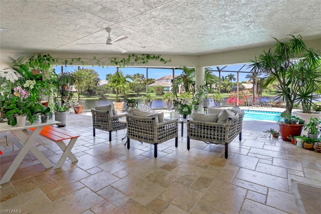 619 Neapolitan Way Naples, FL 34103 - Photo 23 of 32 a outdoor living space with furniture and a potted plant