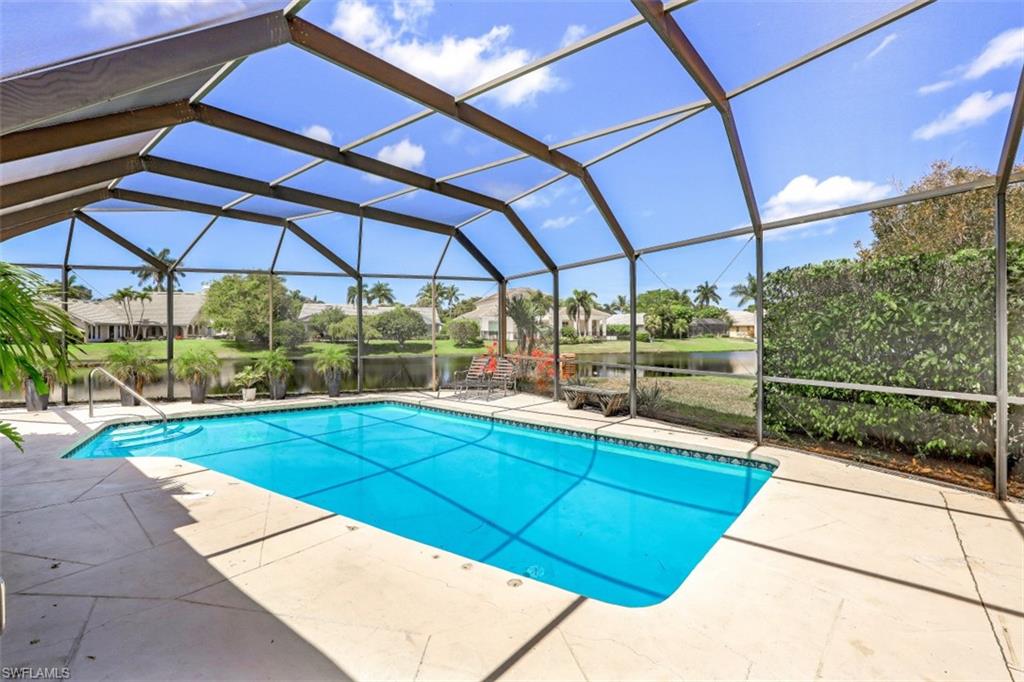 619 Neapolitan Way Naples, FL 34103 - Photo 26 of 32 a view of a backyard with sitting area
