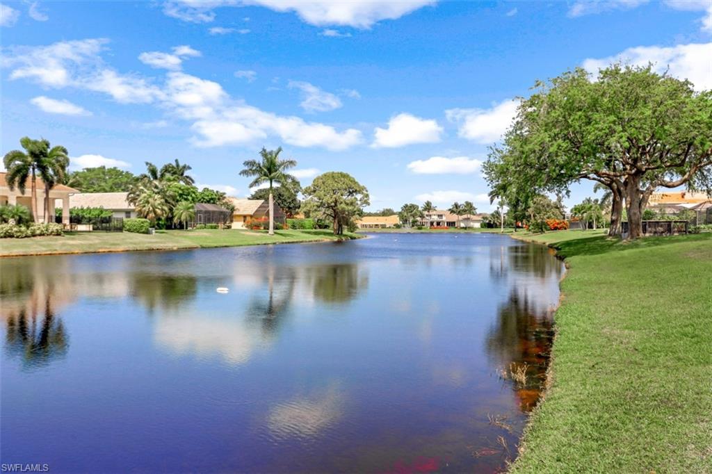 619 Neapolitan Way Naples, FL 34103 - Photo 28 of 32 a view of a lake with houses in the back