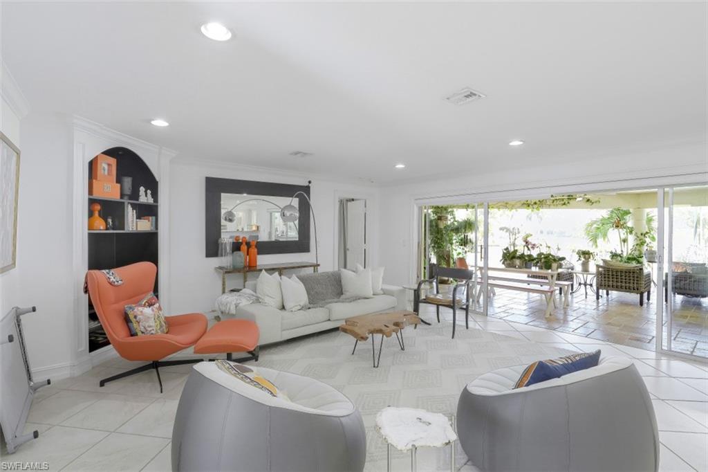 619 Neapolitan Way Naples, FL 34103 - Photo 6 of 32 a living room with furniture and a large window