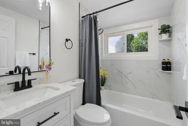a bathroom with a sink a toilet and a bathtub