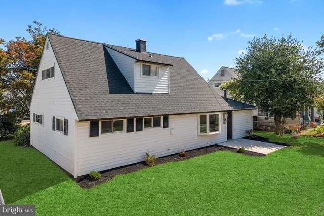 a aerial view of a house with a yard and deck