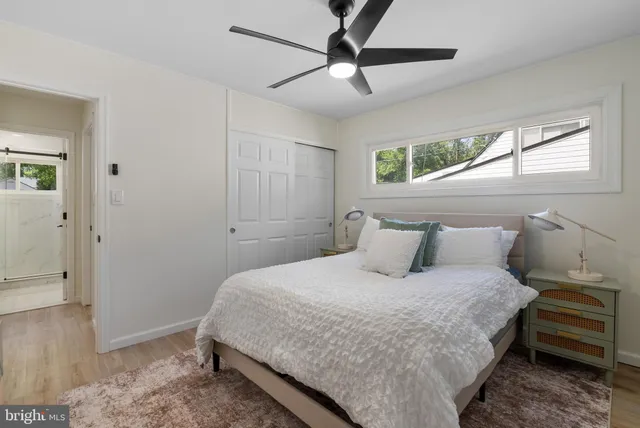 a bedroom with a large bed and a window