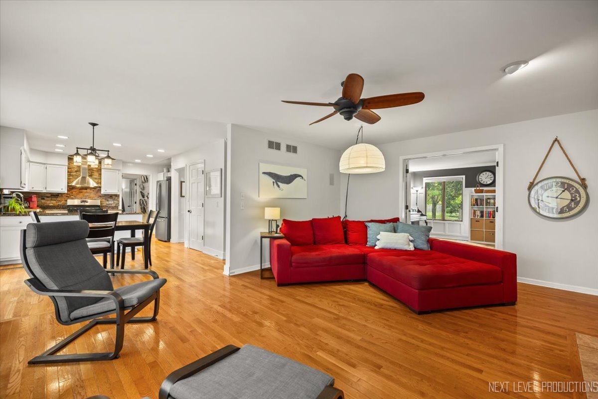 92 Red Fox Run Montgomery, IL 60538 - Photo 12 of 25 a living room with furniture a clock on wall and a large window