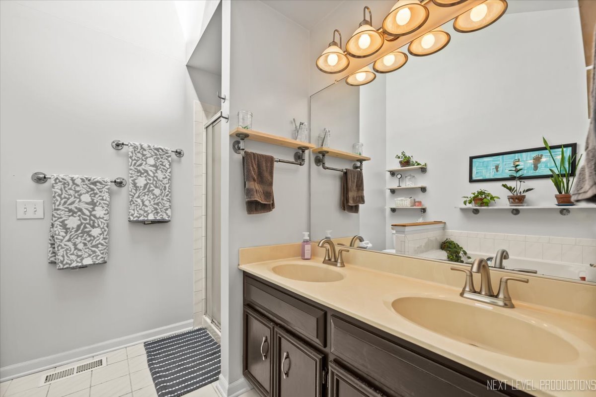 92 Red Fox Run Montgomery, IL 60538 - Photo 18 of 25 a bathroom with a sink double vanity and a mirror