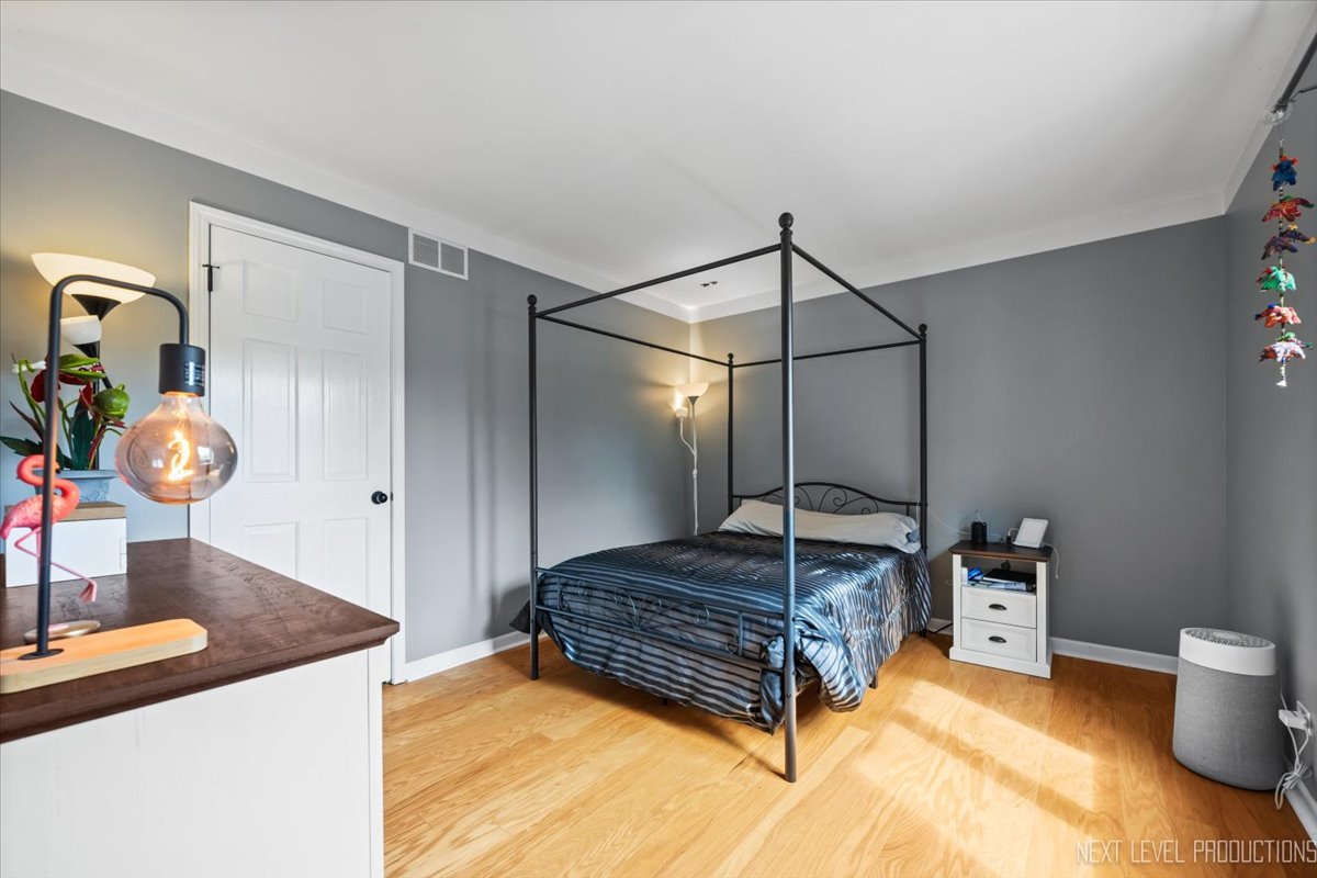 92 Red Fox Run Montgomery, IL 60538 - Photo 21 of 25 a spacious bedroom with a bed and a chandelier