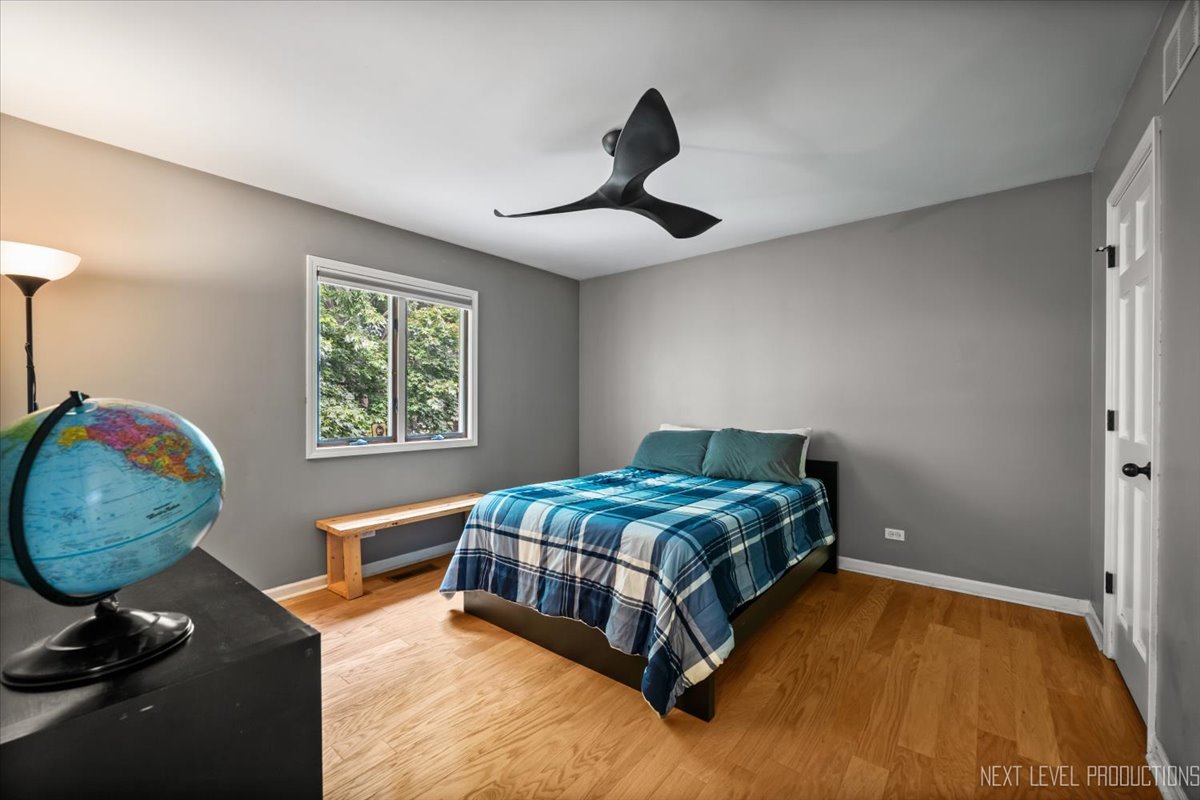 92 Red Fox Run Montgomery, IL 60538 - Photo 22 of 25 a bedroom with a bed and a chandelier