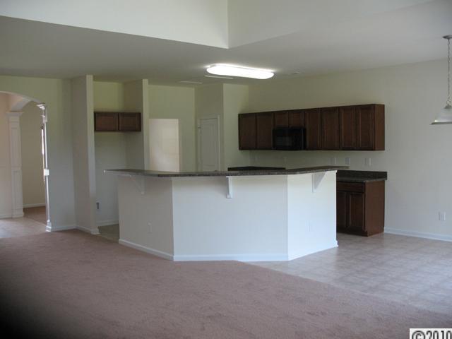 424 Rook Road Charlotte, NC 28216 - Photo 3 of 6 a kitchen with stainless steel appliances granite countertop a stove a microwave and a sink