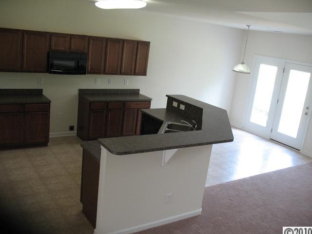 424 Rook Road Charlotte, NC 28216 - Photo 4 of 6 a kitchen with granite countertop a cabinets and a stove top oven