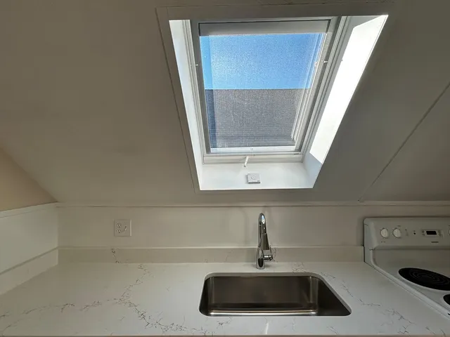 a bathroom with a tub shower vanity and a sink