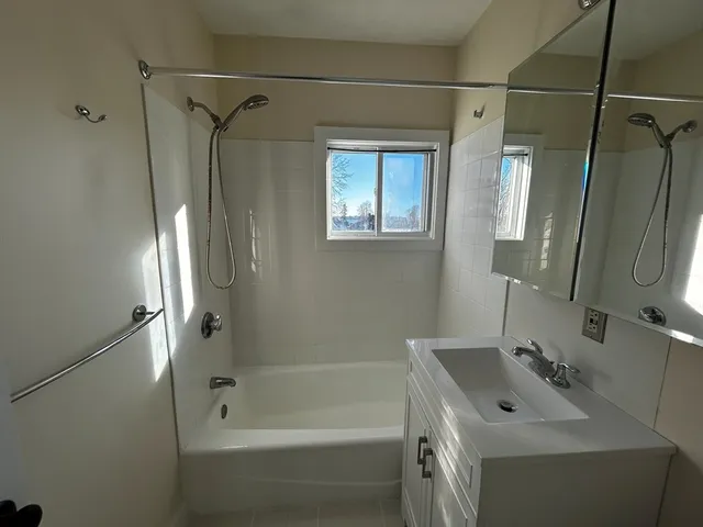 a view of an empty room and wooden floor