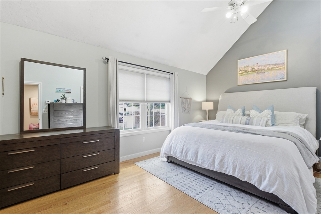 27 Emerson Street, Unit 27 Stoneham, MA 02180 - Photo 12 of 29 a bedroom with a bed and a mirror on dresser