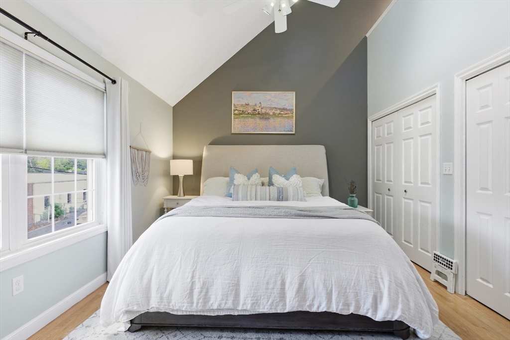 27 Emerson Street, Unit 27 Stoneham, MA 02180 - Photo 13 of 29 a bedroom with a large bed and a window