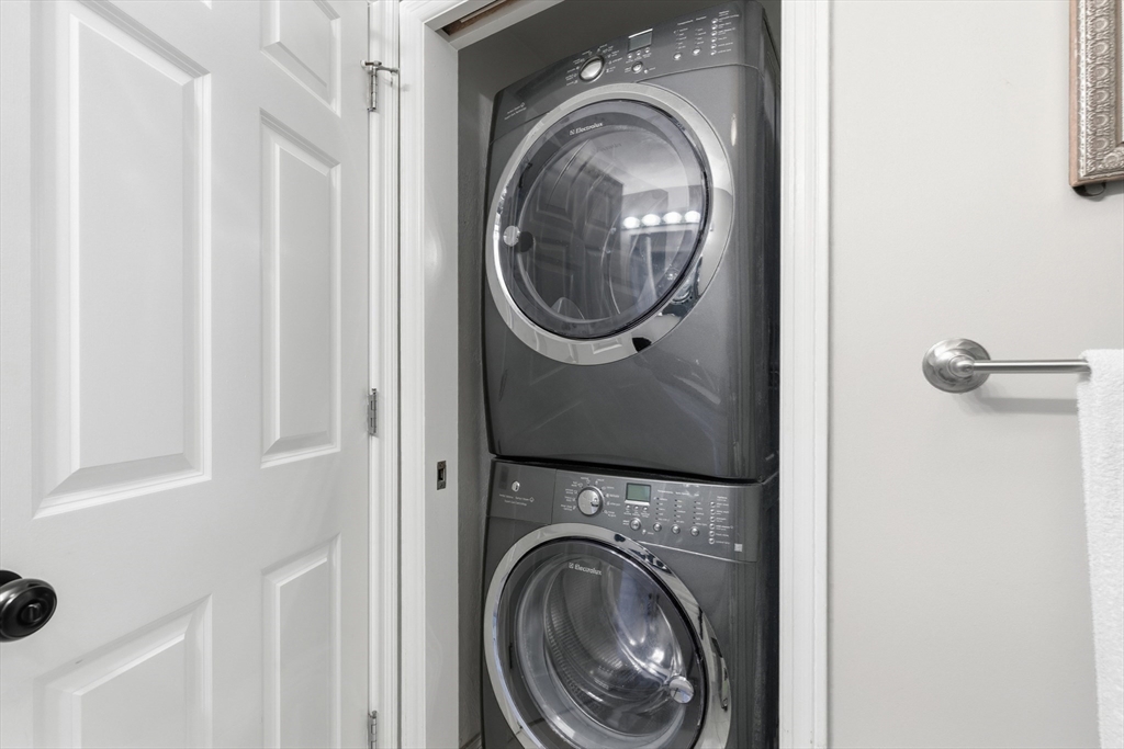 27 Emerson Street, Unit 27 Stoneham, MA 02180 - Photo 15 of 29 a view of a hallway with washer and dryer