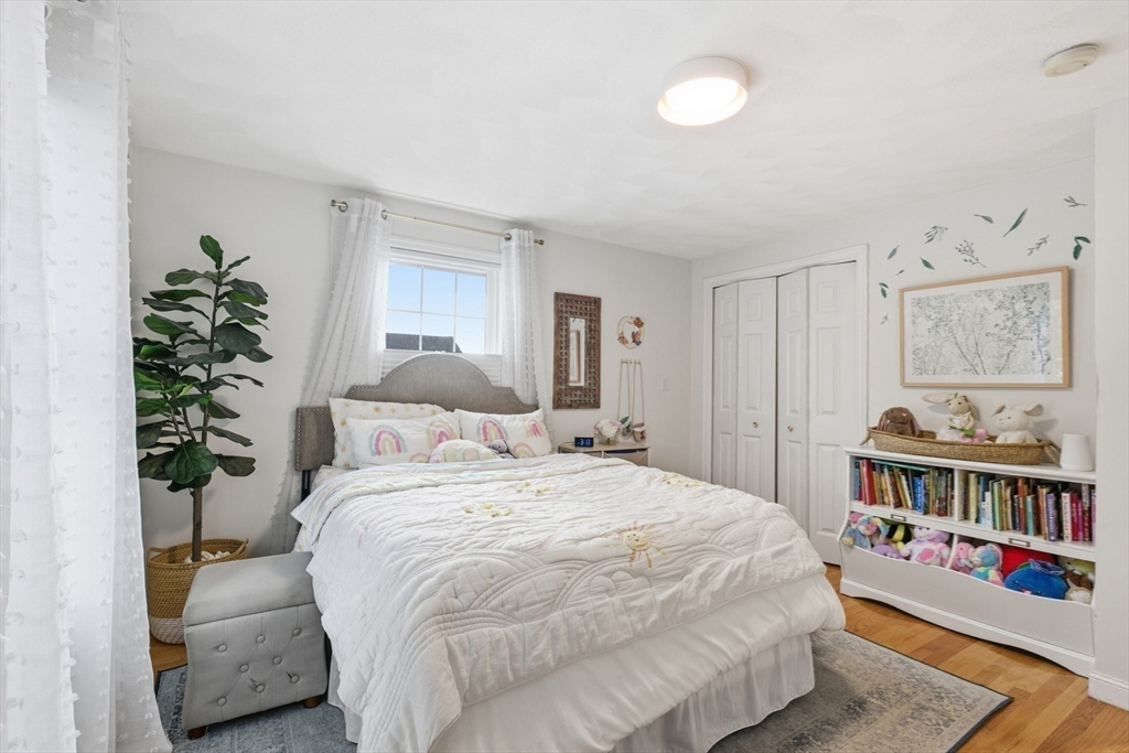27 Emerson Street, Unit 27 Stoneham, MA 02180 - Photo 16 of 29 a bedroom with a bed and a book shelf
