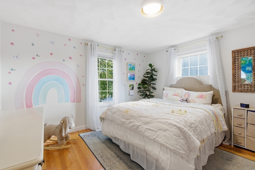 27 Emerson Street, Unit 27 Stoneham, MA 02180 - Photo 17 of 29 a bedroom with a bed and a window