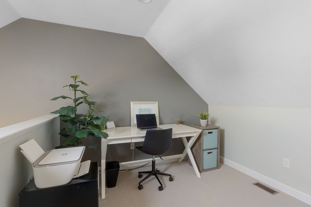 27 Emerson Street, Unit 27 Stoneham, MA 02180 - Photo 18 of 29 a workspace with furniture and a potted plant