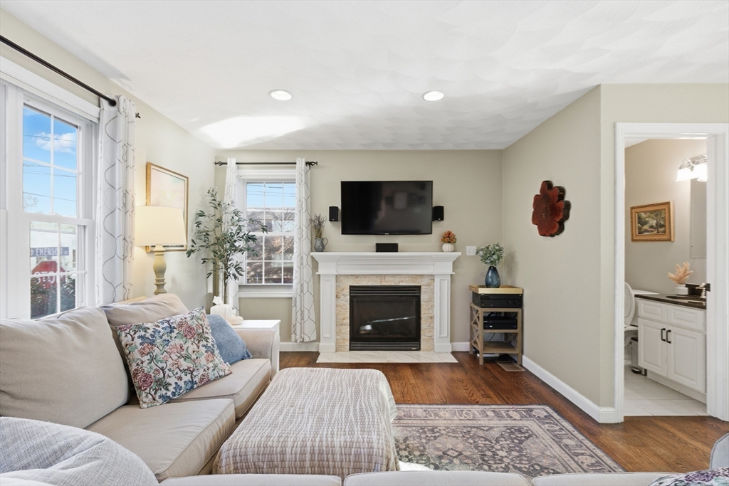 27 Emerson Street, Unit 27 Stoneham, MA 02180 - Photo 2 of 29 a living room with furniture a fireplace and a flat screen tv