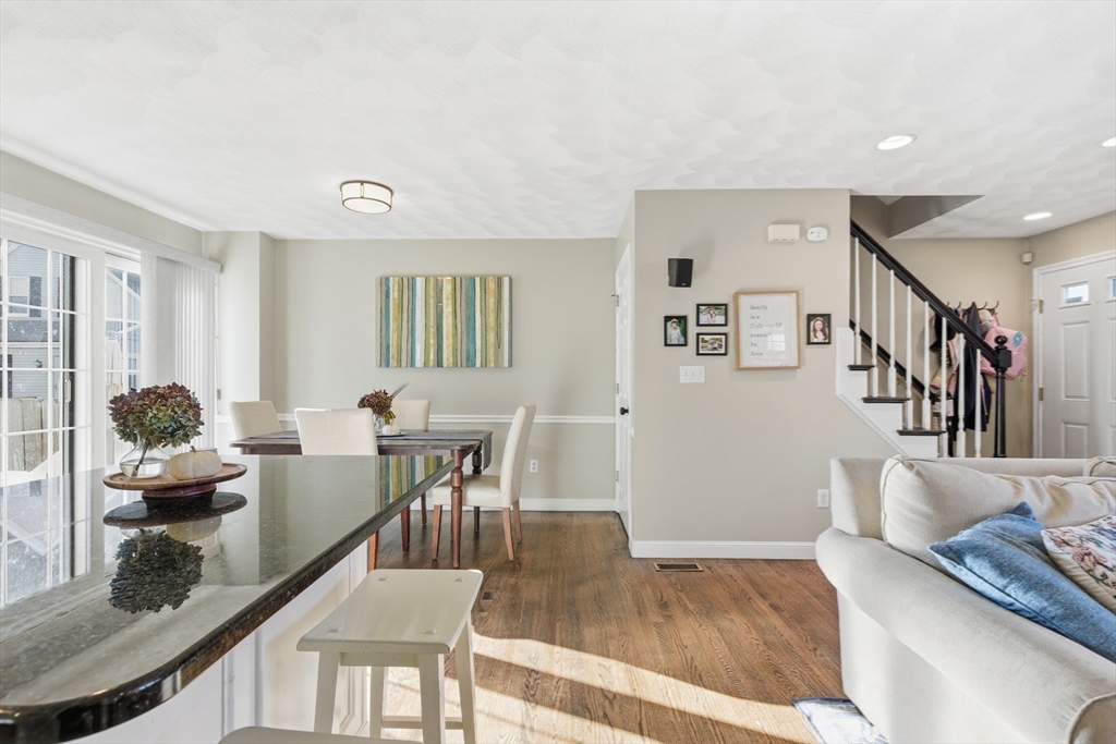 27 Emerson Street, Unit 27 Stoneham, MA 02180 - Photo 4 of 29 a living room with furniture and wooden floor
