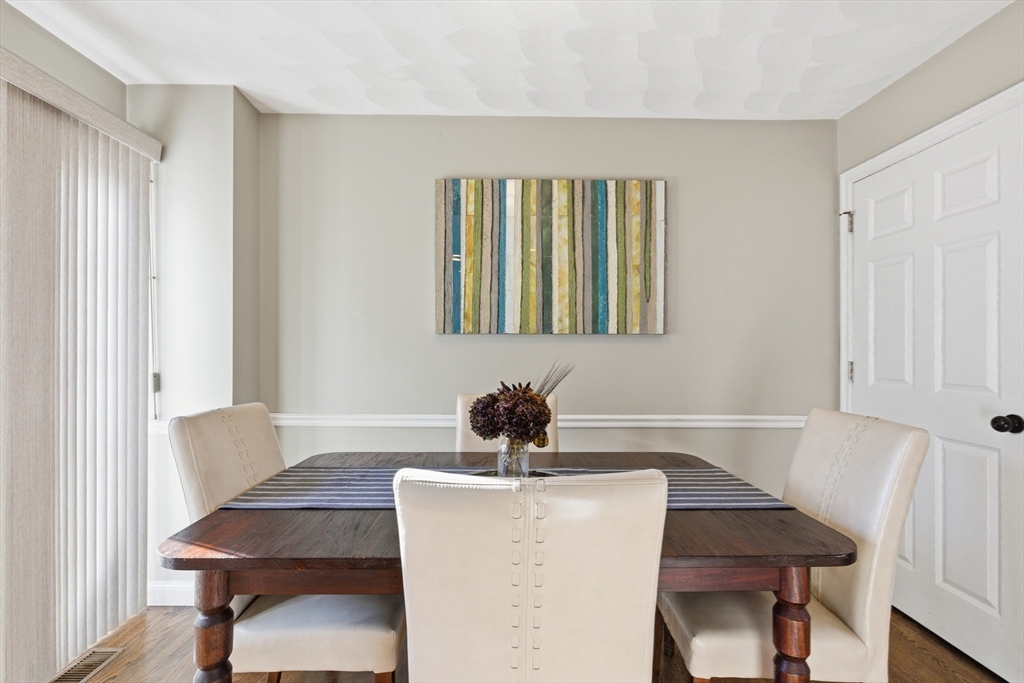 27 Emerson Street, Unit 27 Stoneham, MA 02180 - Photo 5 of 29 a dining room with furniture and window