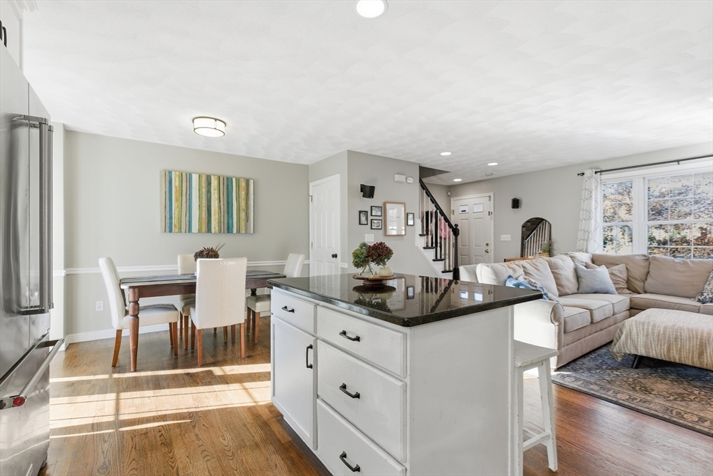 27 Emerson Street, Unit 27 Stoneham, MA 02180 - Photo 7 of 29 a living room with furniture and a dining table with garden view