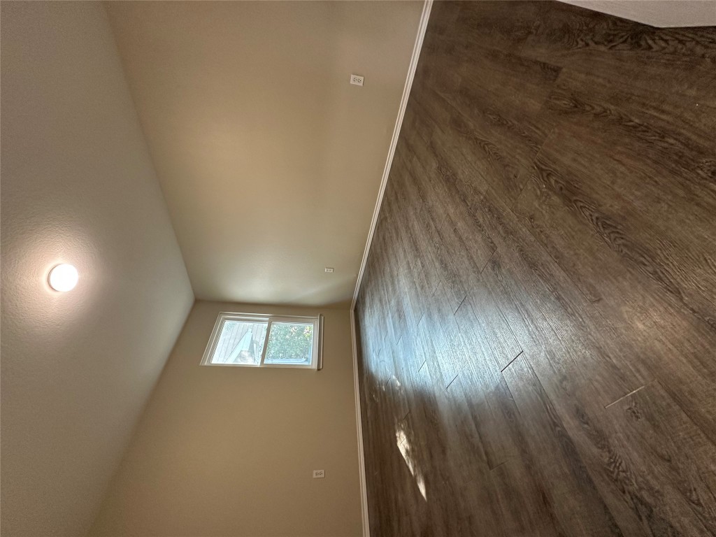 3416 Autumn Bay Drive Austin, TX 78744 - Photo 10 of 14 an empty room with wooden floor and windows