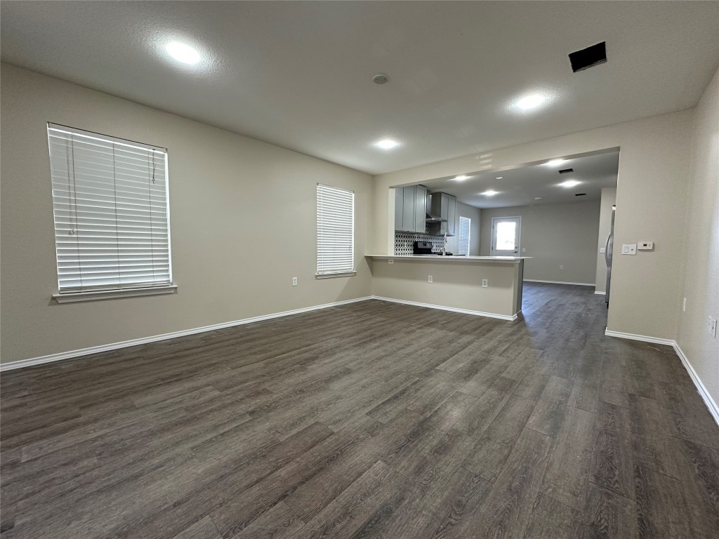 3416 Autumn Bay Drive Austin, TX 78744 - Photo 3 of 14 an empty room with wooden floor and windows