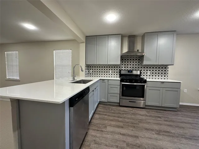 a kitchen with granite countertop a sink and cabinets