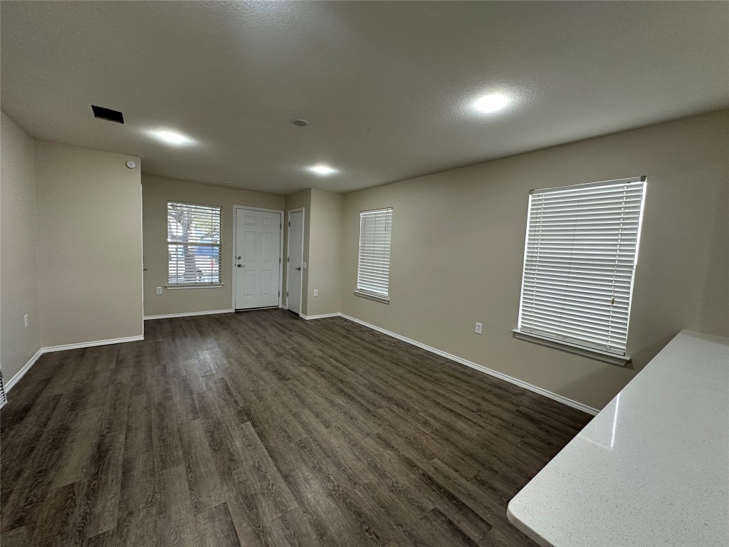3416 Autumn Bay Drive Austin, TX 78744 - Photo 5 of 14 an empty room with wooden floor and windows