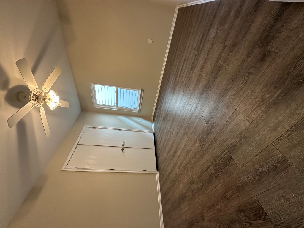 3416 Autumn Bay Drive Austin, TX 78744 - Photo 9 of 14 an empty room with wooden floor fan and windows
