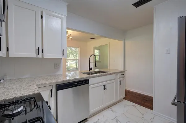 a kitchen with a sink stove and cabinets