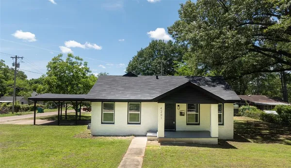 a front view of a house with a yard and porch