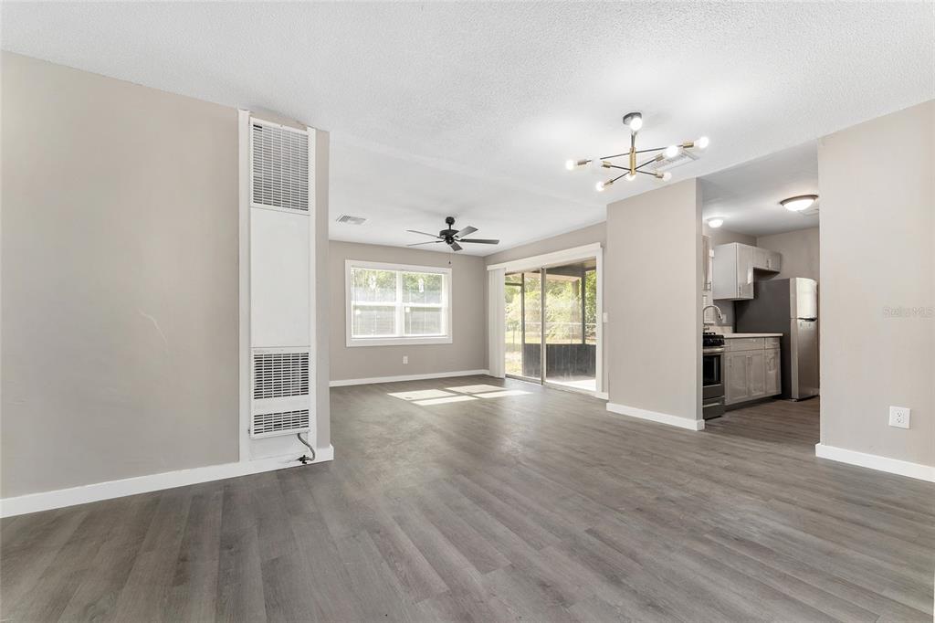 919 Southeast 19th Street Gainesville, FL 32641 - Photo 15 of 50 a view of empty room with wooden floor and fan